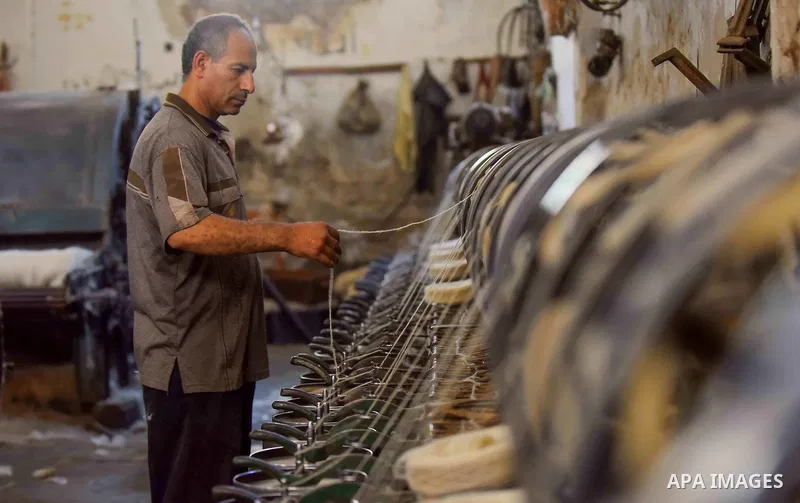 A worker prepares wool for production in a factory in Beheira Governorate, Egypt on September 3, 2016. Photo by Amr Sayed