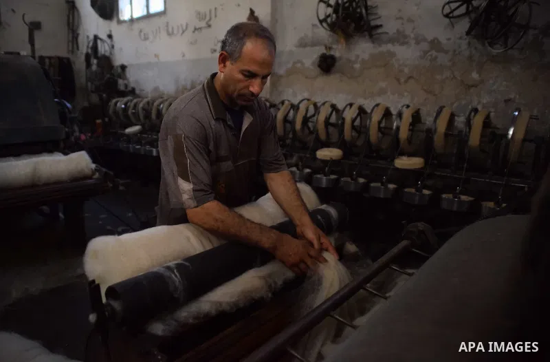 A worker prepares wool for production in a factory in Beheira Governorate, Egypt on September 3, 2016. Photo by Amr Sayed