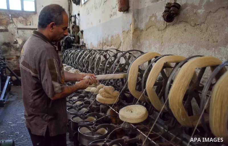 A worker prepares wool for production in a factory in Beheira Governorate, Egypt on September 3, 2016. Photo by Amr Sayed