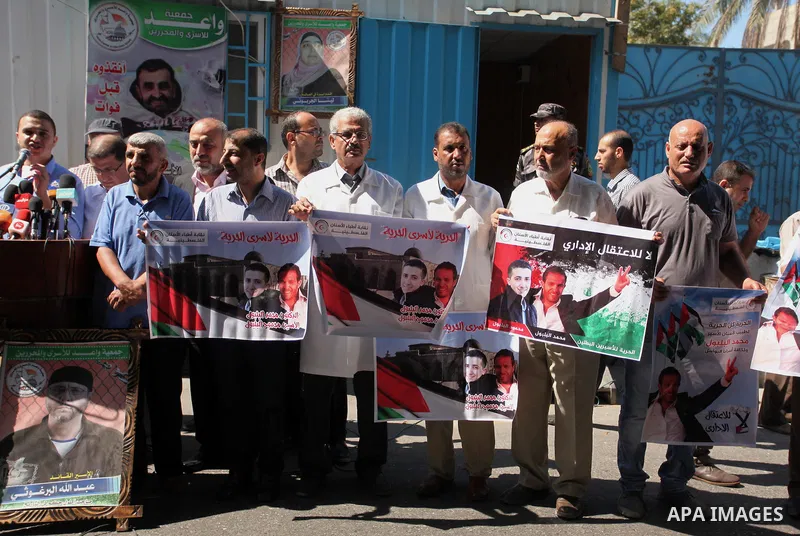 Palestinians hold banners during a protest to show solidarity with Palestinian prisoners on hunger strike in Israeli Jails, in front of United Nations Development Programme office (UNDP), in Gaza City, on Sept. 18, 2016....