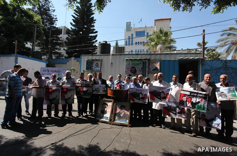 Palestinians hold banners during a protest to show solidarity with Palestinian prisoners on hunger strike in Israeli Jails, in front of United Nations Development Programme office (UNDP), in Gaza City, on Sept. 18, 2016....