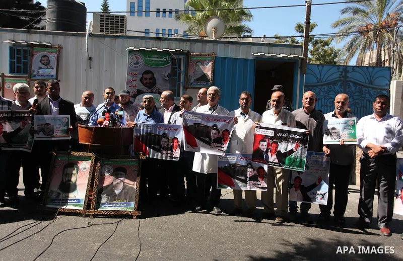 Palestinians hold banners during a protest to show solidarity with Palestinian prisoners on hunger strike in Israeli Jails, in front of United Nations Development Programme office (UNDP), in Gaza City, on Sept. 18, 2016....