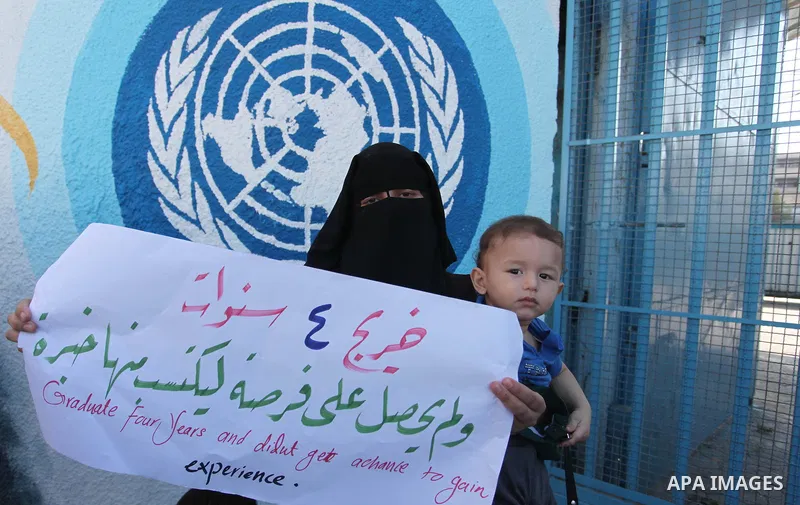 Palestinian teachers and graduates take part a protest demanding their rights in front of the headquarters United Nations Relief and Works Agency (UNRWA), in Gaza City, on Sept. 18, 2016. Photo by Ashraf Amra