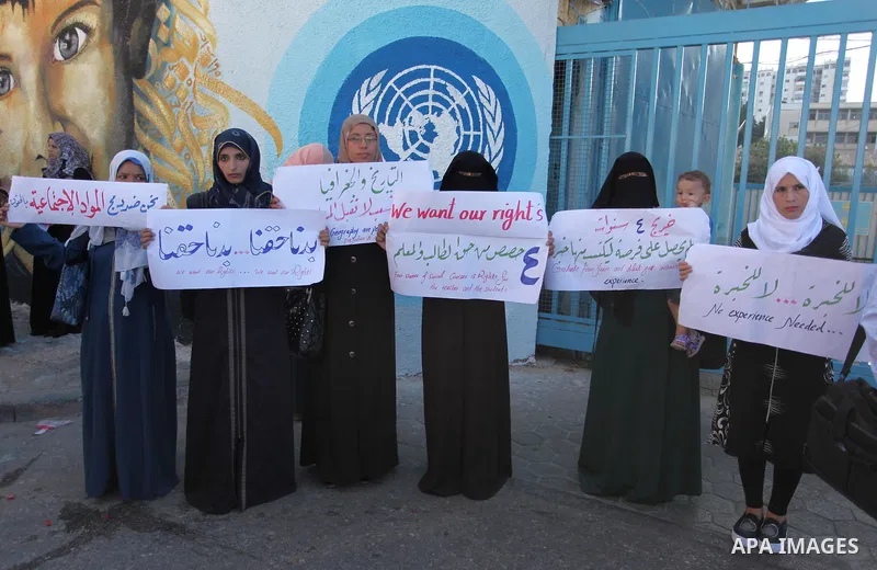 Palestinian teachers and graduates take part a protest demanding their rights in front of the headquarters United Nations Relief and Works Agency (UNRWA), in Gaza City, on Sept. 18, 2016. Photo by Ashraf Amra