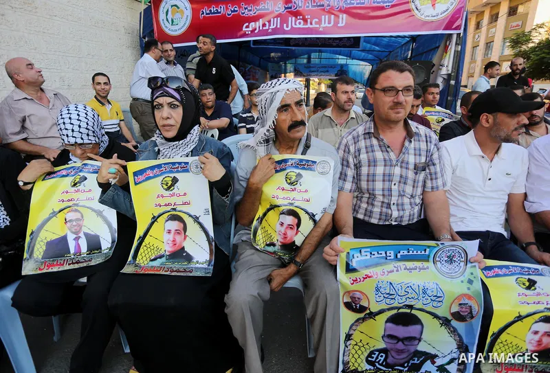 Palestinian supporters of Fatah movement take part during a protest to show solidarity with Palestinian prisoners on hunger strike in Israeli Jails, in front of Red cross office in Gaza city, on Sept. 18, 2016. Photo by...