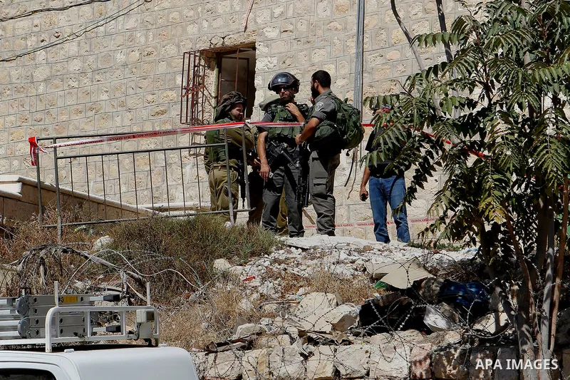 Israeli security forces cordon off the area around the body of a Palestinian, who was shot during a reported stabbing attack against Israeli officers, near the Ibrahimi mosque, or the Tomb of the Patriarch, a religious s...