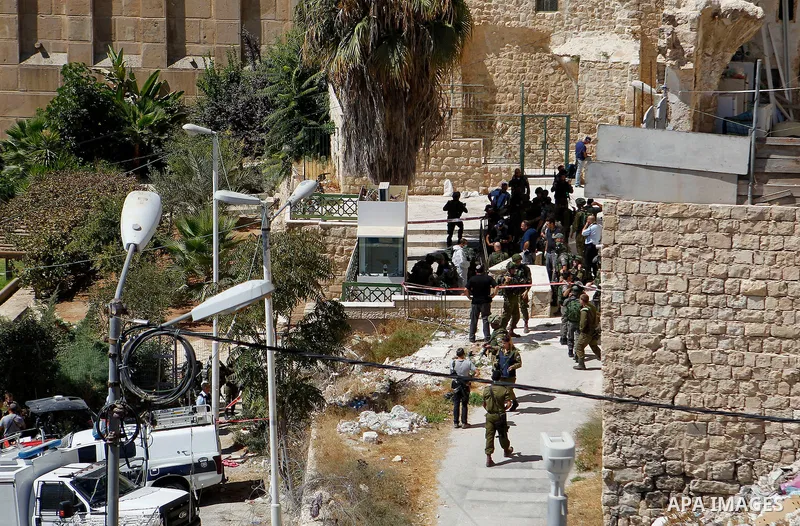 Israeli security forces cordon off the area around the body of a Palestinian, who was shot during a reported stabbing attack against Israeli officers, near the Ibrahimi mosque, or the Tomb of the Patriarch, a religious s...