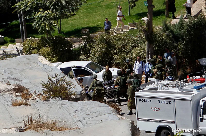 Israeli security forces carry the body of a Palestinian, who was shot during a reported stabbing attack against Israeli officers, near the Ibrahimi mosque, or the Tomb of the Patriarch, a religious site to both Muslims a...