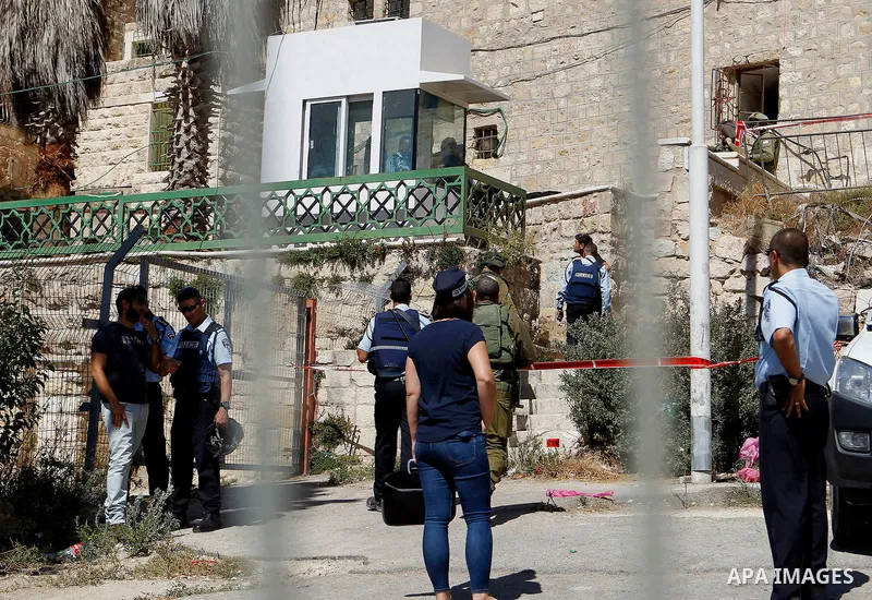Israeli security forces cordon off the area around the body of a Palestinian, who was shot during a reported stabbing attack against Israeli officers, near the Ibrahimi mosque, or the Tomb of the Patriarch, a religious s...