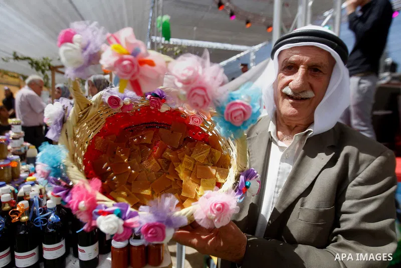 Palestinians take part during the Palestinian grapes festival in Halhoul village, near the West Bank city of Hebron, on Sept. 19, 2016. Hebron is very famous in grape production as it contains many fields of grapes, the...