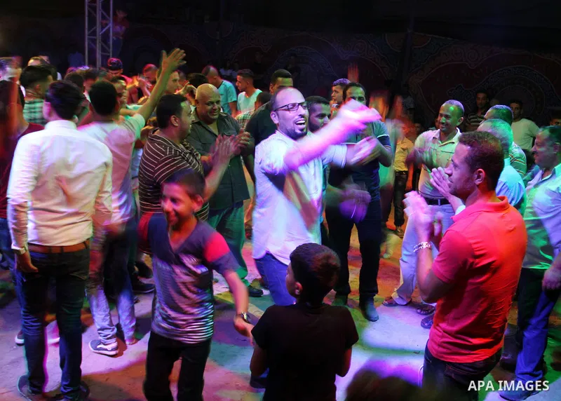 Palestinians celebrate during a traditional wedding party in Arabic "Henna's Night" in Rafah in the southern Gaza strip on Sep. 20, 2016. Palestinians perform the traditional dancing style derived from their folklore, th...
