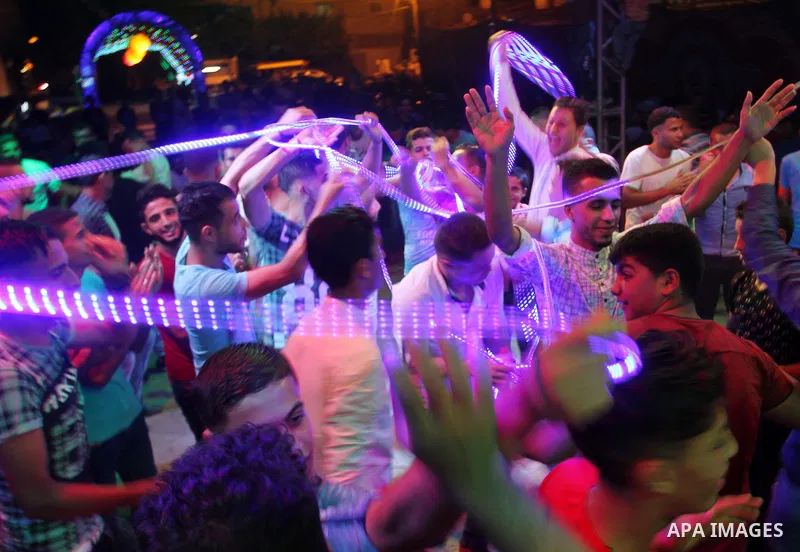 Palestinians celebrate during a traditional wedding party in Arabic "Henna's Night" in Rafah in the southern Gaza strip on Sep. 20, 2016. Palestinians perform the traditional dancing style derived from their folklore, th...