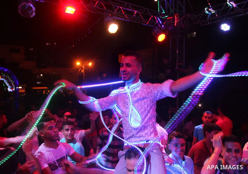 Palestinians celebrate during a traditional wedding party in Arabic "Henna's Night" in Rafah in the southern Gaza strip on Sep. 20, 2016. Palestinians perform the traditional dancing style derived from their folklore, th...