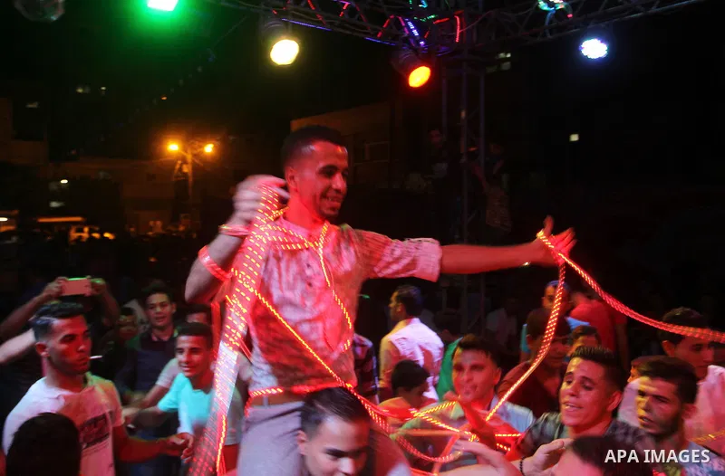 Palestinians celebrate during a traditional wedding party in Arabic "Henna's Night" in Rafah in the southern Gaza strip on Sep. 20, 2016. Palestinians perform the traditional dancing style derived from their folklore, th...