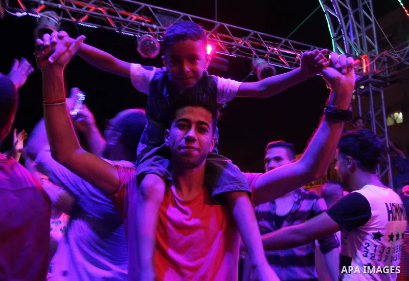 Palestinians celebrate during a traditional wedding party in Arabic "Henna's Night" in Rafah in the southern Gaza strip on Sep. 20, 2016. Palestinians perform the traditional dancing style derived from their folklore, th...