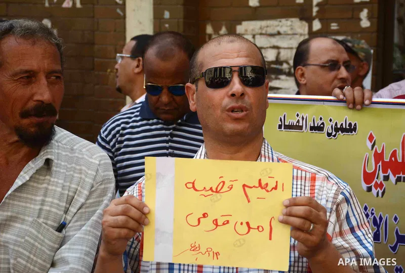 Egyptian teachers hold placards during a demonstration against the education system and demanding the resignation of Education Minister Al-Helali el-Sherbini outside Journalists' Syndicate in Cairo, Egypt, on Sep. 20, 20...