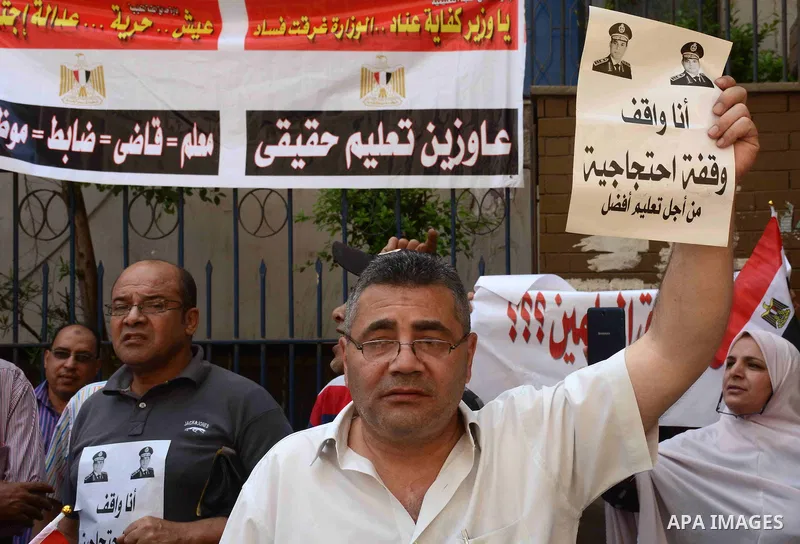 Egyptian teachers hold placards during a demonstration against the education system and demanding the resignation of Education Minister Al-Helali el-Sherbini outside Journalists' Syndicate in Cairo, Egypt, on Sep. 20, 20...