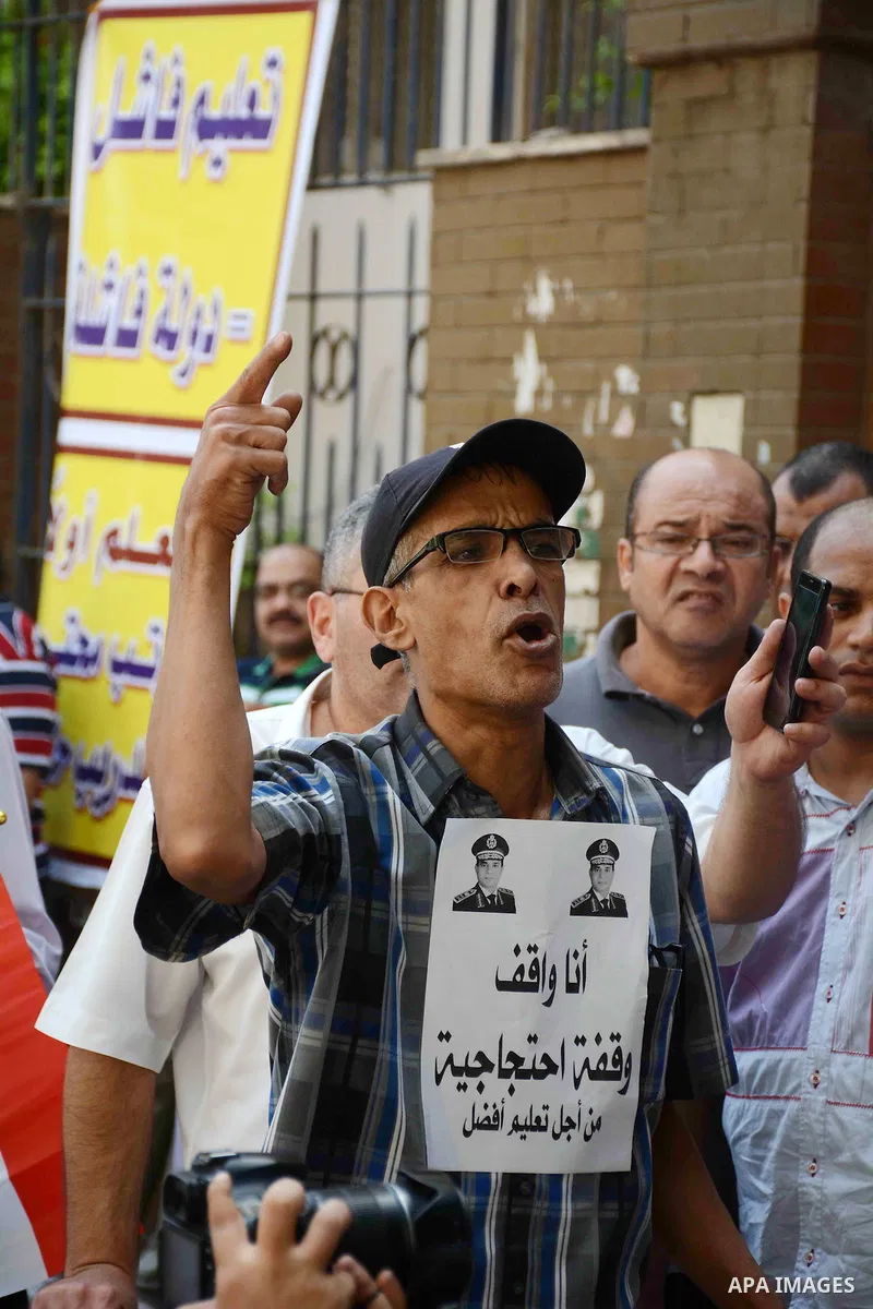 Egyptian teachers hold placards during a demonstration against the education system and demanding the resignation of Education Minister Al-Helali el-Sherbini outside Journalists' Syndicate in Cairo, Egypt, on Sep. 20, 20...