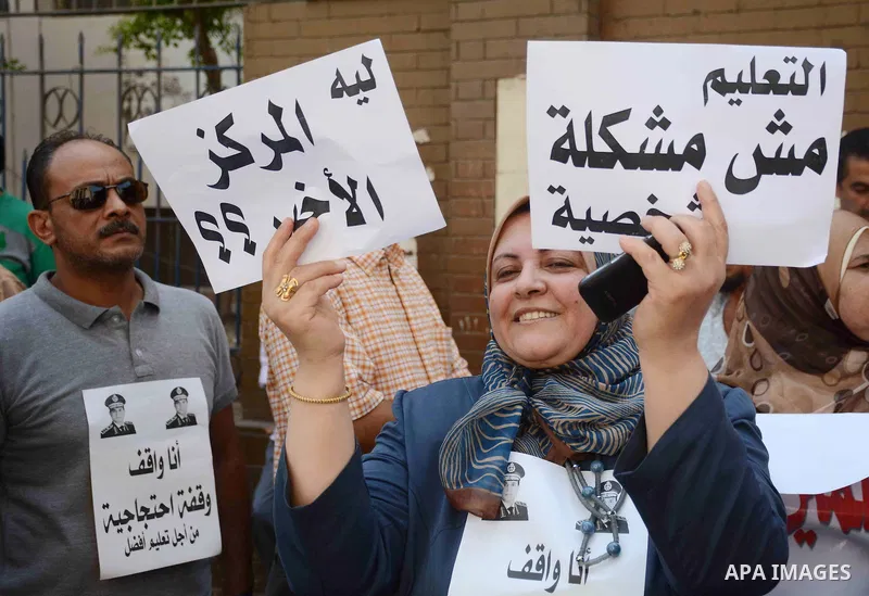 Egyptian teachers hold placards during a demonstration against the education system and demanding the resignation of Education Minister Al-Helali el-Sherbini outside Journalists' Syndicate in Cairo, Egypt, on Sep. 20, 20...