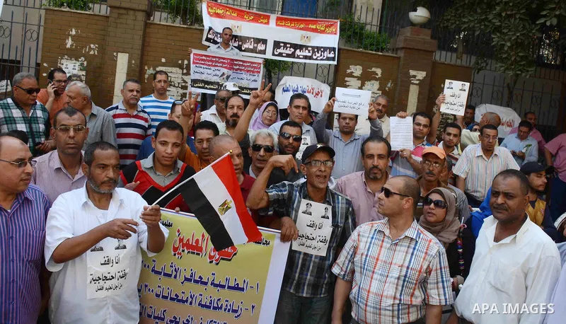Egyptian teachers hold placards during a demonstration against the education system and demanding the resignation of Education Minister Al-Helali el-Sherbini outside Journalists' Syndicate in Cairo, Egypt, on Sep. 20, 20...