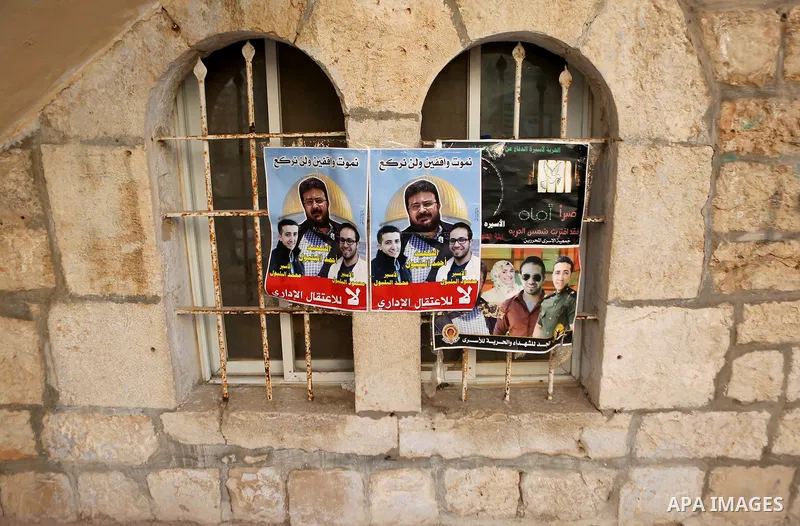 A Poster bearing pictures of Palestinian prisoners Mohammed and Mahmoud Balboul who are on hunger strike is seen in their house in the West Bank city of Bethlehem on Sep. 20, 2016. Mohammed Balboul began his own hunger s...
