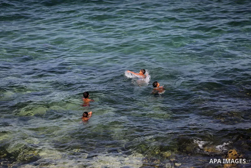 Palestinian boys swim at Gaza's seaport of Gaza City, on Sept. 21, 2016. Photo by Mohammed Asad