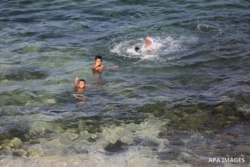 Palestinian boys swim at Gaza's seaport of Gaza City, on Sept. 21, 2016. Photo by Mohammed Asad