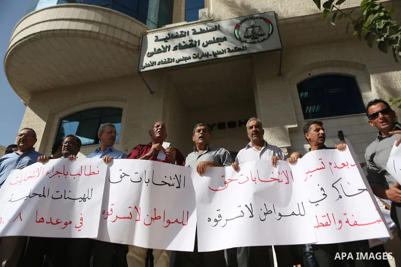 Palestinians demonstrate in front of the Supreme Court in the West Bank city of Ramallah calling authorities not to postpone local elections, on September 21, 2016. Palestinian municipal polls scheduled for October 8 wer...