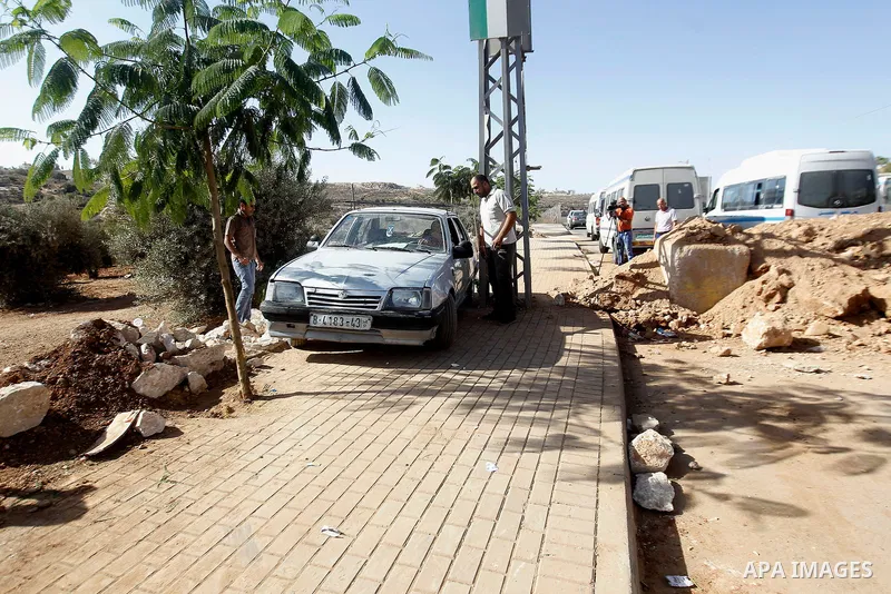 Palestinians cross the closed at the entrance to the West Bank village of Bani Na'im, near Hebron September 21 2016. the Israeli army applied a closure at areas where Palestinian assailants live or attacked Israeli troop...