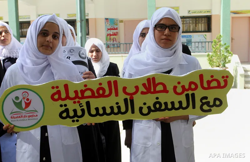Palestinian students from al-Fadela school take part in a rally supporting of a Gaza-bound flotilla of international activists attempting to break the Gaza blockade, in Rafah in the southern Gaza strip on September 25, 2...