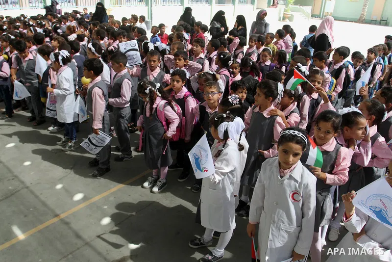Palestinian students from al-Fadela school take part in a rally supporting of a Gaza-bound flotilla of international activists attempting to break the Gaza blockade, in Rafah in the southern Gaza strip on September 25, 2...