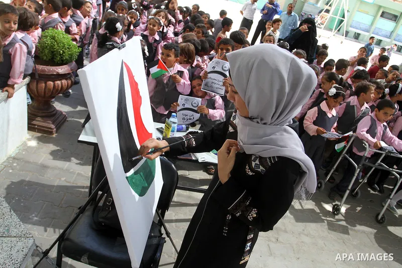 A Palestinian artist paints artwork in a rally supporting of a Gaza-bound flotilla of international activists attempting to break the Gaza blockade, in Rafah in the southern Gaza strip on September 25, 2016. Photo by Abe...