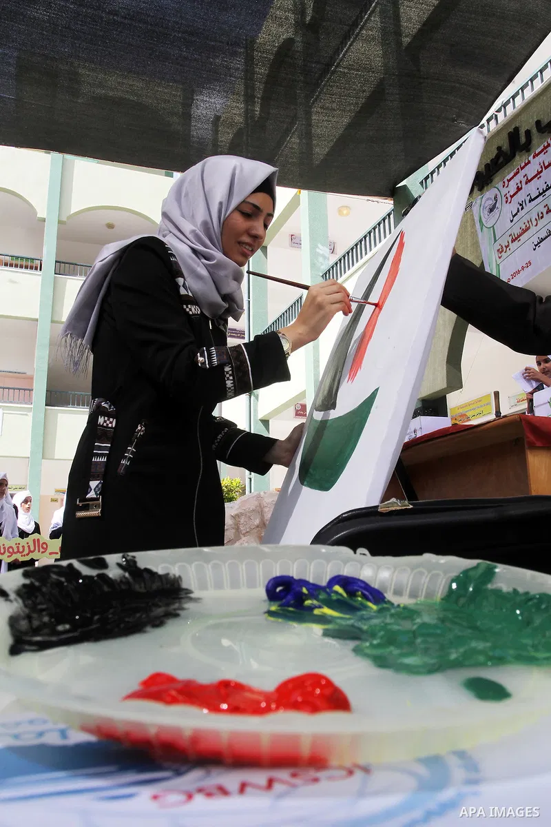 A Palestinian artist paints artwork in a rally supporting of a Gaza-bound flotilla of international activists attempting to break the Gaza blockade, in Rafah in the southern Gaza strip on September 25, 2016. Photo by Abe...