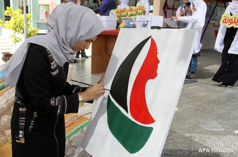 A Palestinian artist paints artwork in a rally supporting of a Gaza-bound flotilla of international activists attempting to break the Gaza blockade, in Rafah in the southern Gaza strip on September 25, 2016. Photo by Abe...