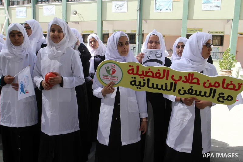Palestinian students from al-Fadela school take part in a rally supporting of a Gaza-bound flotilla of international activists attempting to break the Gaza blockade, in Rafah in the southern Gaza strip on September 25, 2...