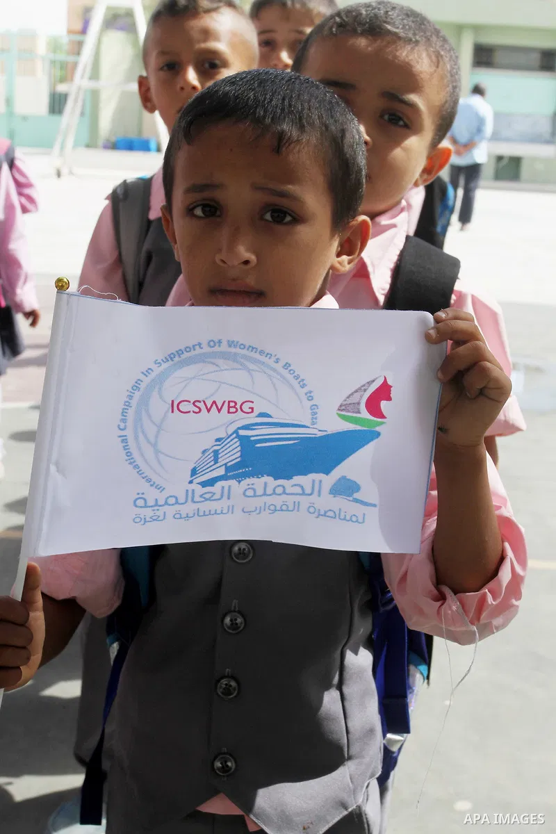 Palestinian students from al-Fadela school take part in a rally supporting of a Gaza-bound flotilla of international activists attempting to break the Gaza blockade, in Rafah in the southern Gaza strip on September 25, 2...