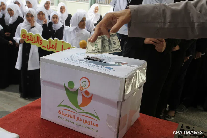 Palestinian students from al-Fadela school donates money during a rally supporting of a Gaza-bound flotilla of international activists attempting to break the Gaza blockade, in Rafah in the southern Gaza strip on Septemb...