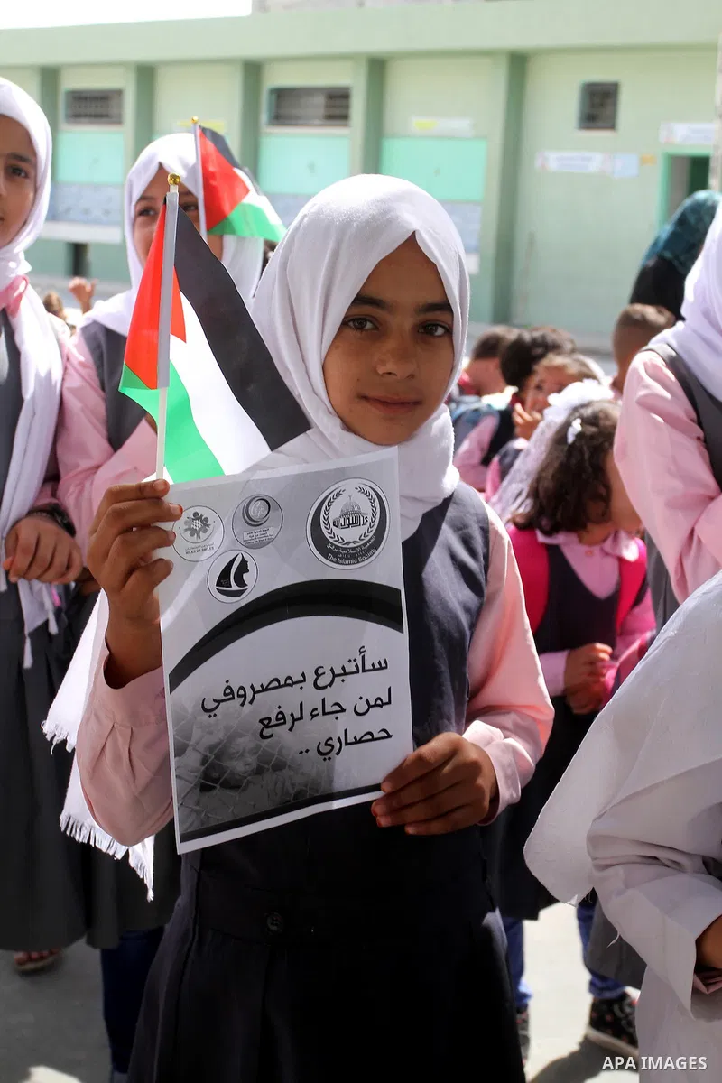 Palestinian students from al-Fadela school take part in a rally supporting of a Gaza-bound flotilla of international activists attempting to break the Gaza blockade, in Rafah in the southern Gaza strip on September 25, 2...