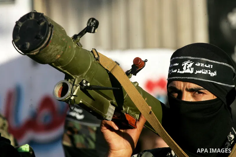 Palestinian militants from the Al-Nasser Brigades, an armed wing of the Popular Resistance Committees (PRC), hold their weapons during a rally in Rafah in the southern Gaza Strip on September 26, 2016, to mark the 17th a...