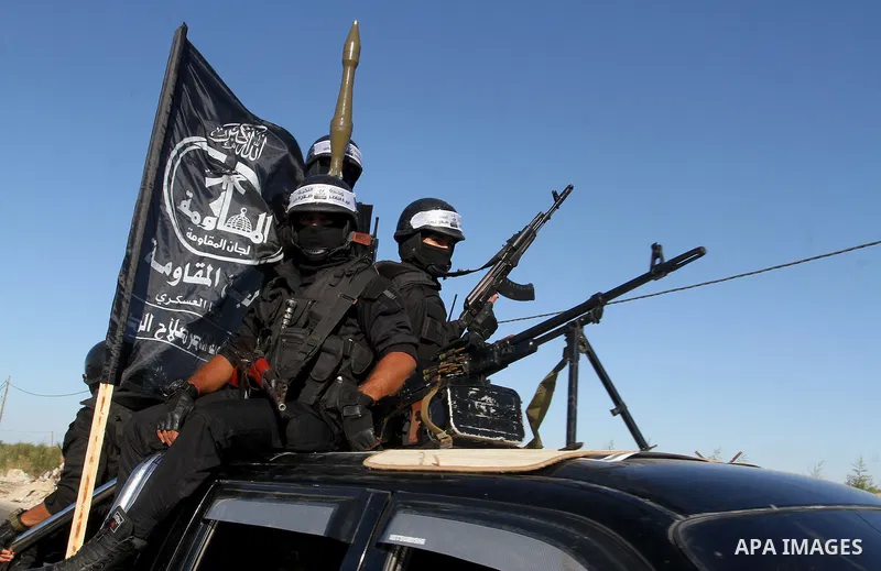 Palestinian militants from the Al-Nasser Brigades, an armed wing of the Popular Resistance Committees (PRC), hold their weapons during a rally in Rafah in the southern Gaza Strip on September 26, 2016, to mark the 17th a...