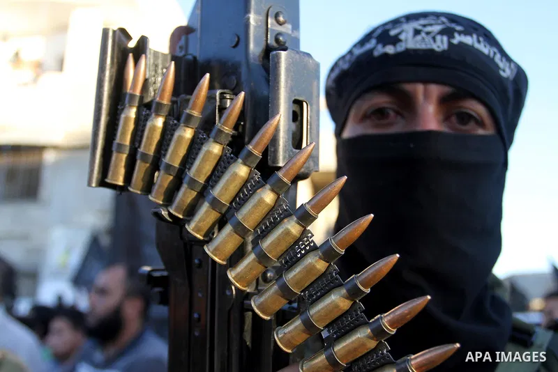 Palestinian militants from the Al-Nasser Brigades, an armed wing of the Popular Resistance Committees (PRC), hold their weapons during a rally in Rafah in the southern Gaza Strip on September 26, 2016, to mark the 17th a...