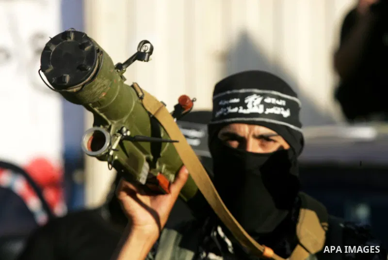Palestinian militants from the Al-Nasser Brigades, an armed wing of the Popular Resistance Committees (PRC), hold their weapons during a rally in Rafah in the southern Gaza Strip on September 26, 2016, to mark the 17th a...