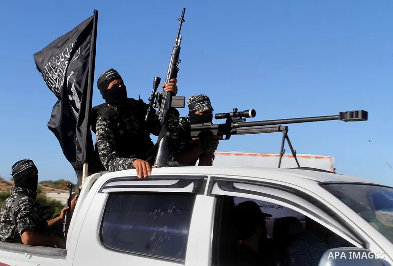 Palestinian militants from the Al-Nasser Brigades, an armed wing of the Popular Resistance Committees (PRC), hold their weapons during a rally in Rafah in the southern Gaza Strip on September 26, 2016, to mark the 17th a...