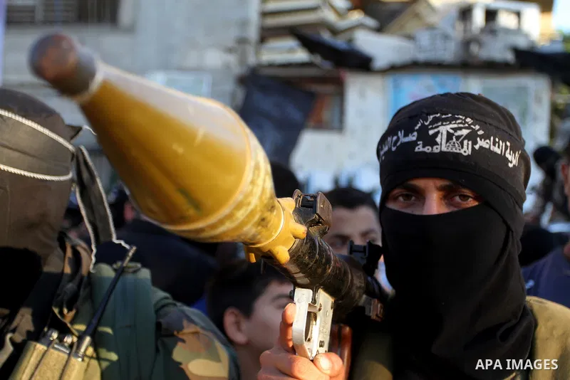 Palestinian militants from the Al-Nasser Brigades, an armed wing of the Popular Resistance Committees (PRC), hold their weapons during a rally in Rafah in the southern Gaza Strip on September 26, 2016, to mark the 17th a...