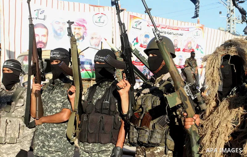 Palestinian militants from the Al-Nasser Brigades, an armed wing of the Popular Resistance Committees (PRC), hold their weapons during a rally in Rafah in the southern Gaza Strip on September 26, 2016, to mark the 17th a...