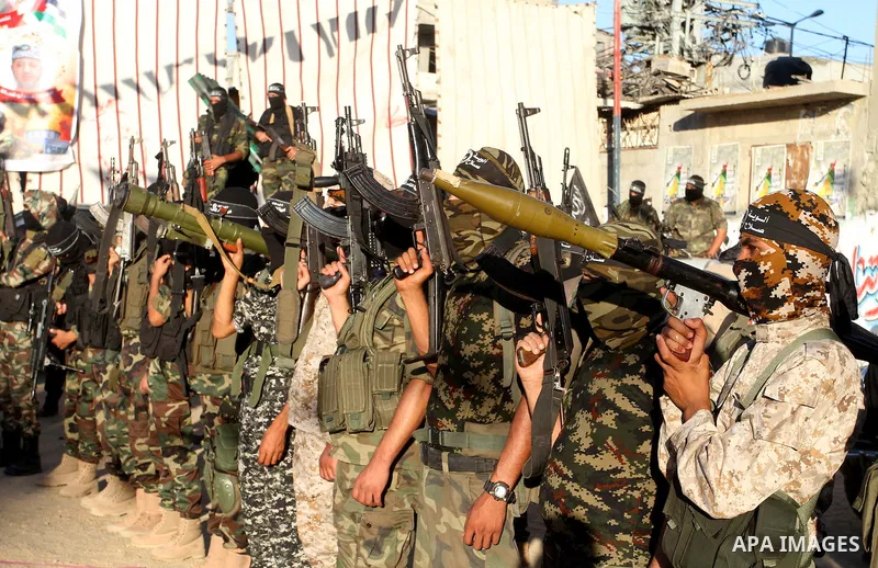 Palestinian militants from the Al-Nasser Brigades, an armed wing of the Popular Resistance Committees (PRC), hold their weapons during a rally in Rafah in the southern Gaza Strip on September 26, 2016, to mark the 17th a...