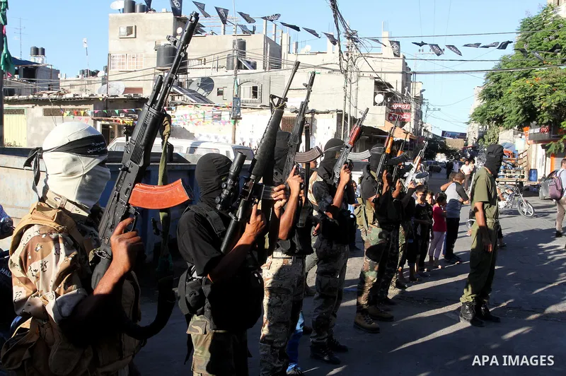 Palestinian militants from the Al-Nasser Brigades, an armed wing of the Popular Resistance Committees (PRC), hold their weapons during a rally in Rafah in the southern Gaza Strip on September 26, 2016, to mark the 17th a...
