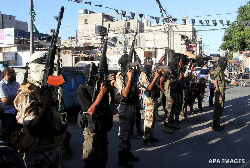 Palestinian militants from the Al-Nasser Brigades, an armed wing of the Popular Resistance Committees (PRC), hold their weapons during a rally in Rafah in the southern Gaza Strip on September 26, 2016, to mark the 17th a...