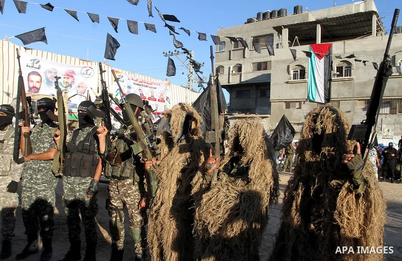 Palestinian militants from the Al-Nasser Brigades, an armed wing of the Popular Resistance Committees (PRC), hold their weapons during a rally in Rafah in the southern Gaza Strip on September 26, 2016, to mark the 17th a...