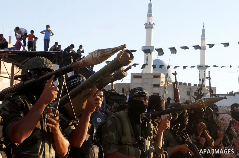 Palestinian militants from the Al-Nasser Brigades, an armed wing of the Popular Resistance Committees (PRC), hold their weapons during a rally in Rafah in the southern Gaza Strip on September 26, 2016, to mark the 17th a...